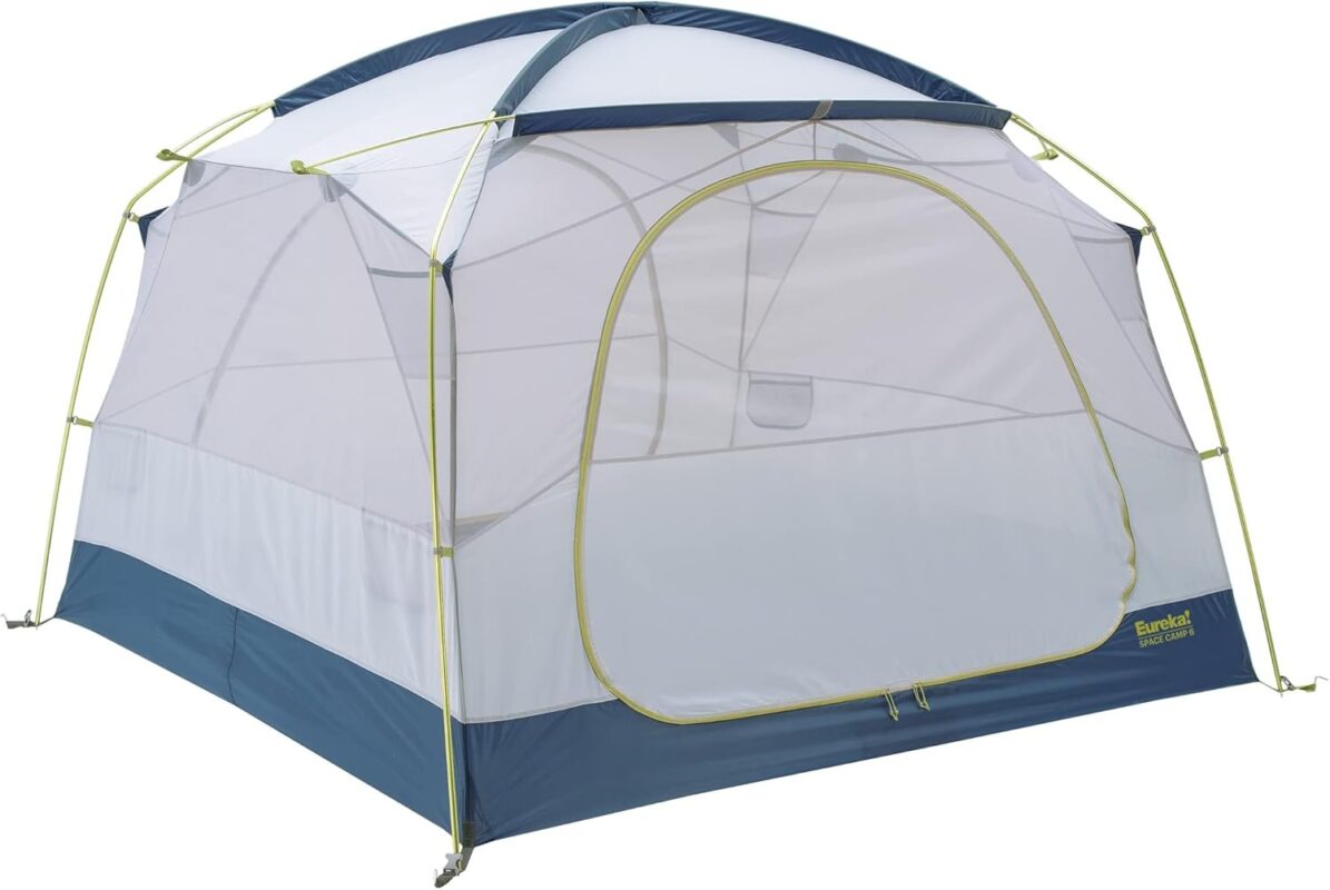 Large blue and grey Eureka Space Camp 6-person tent set up in a wooded campsite with the rainfly fully extended over the vestibule