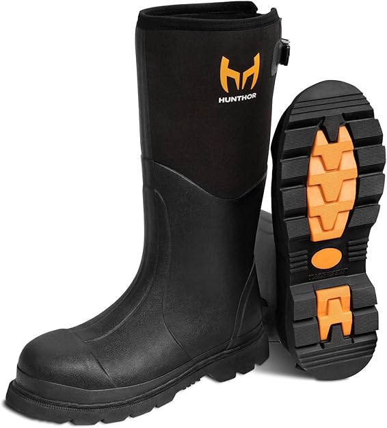 Steel-toe puncture-proof rubber work boots with 6mm neoprene lining standing in deep outdoor mud.