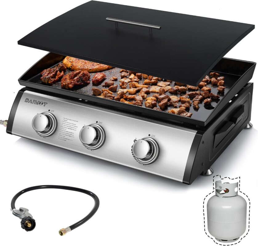 DAIMOT 24 inch Gas Griddle Flat Top Grill with 3 stainless steel burners and a closed lid on a portable camping table.